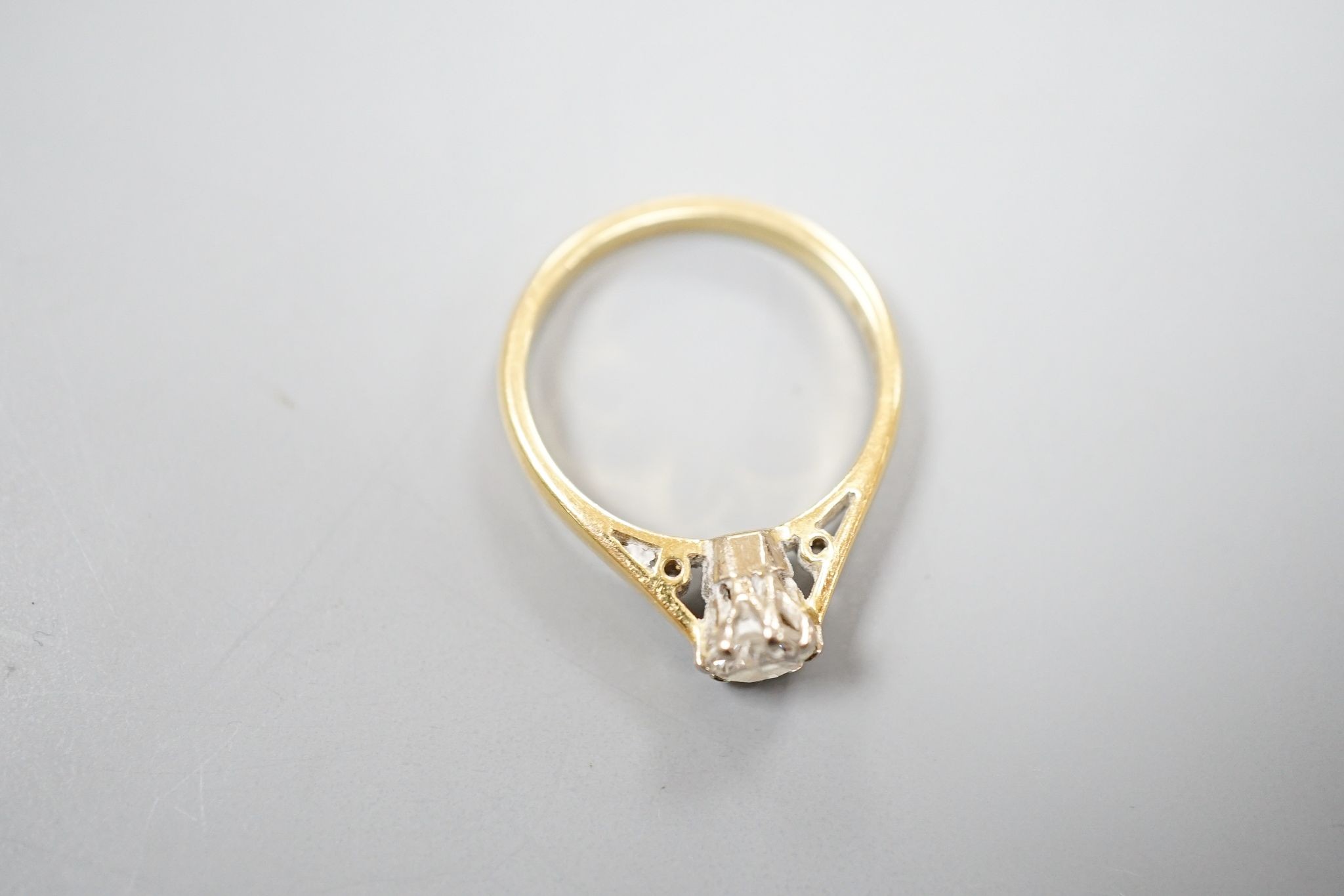 A modern 18ct gold and solitaire diamond ring, size N, gross weight 3.5 grams